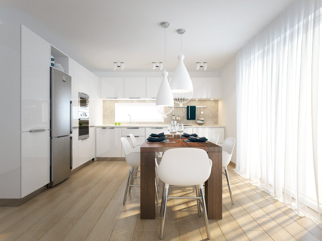 Prirodzeným svetlom presvetlená biela kuchyňa v tvare L so vstavanými spotrebičmi a drevený jedálenský stôl