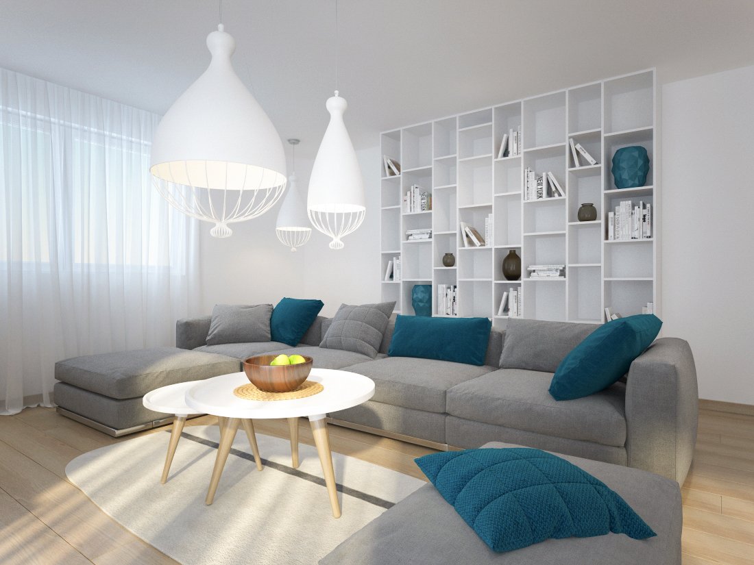 Biela obývačka s knižnicou a šedou dlhou sedačkou doplnenou tyrkysovými výraznými vankúšmi s modernými okrúhlymi stolíkmi a kusovým kobercom