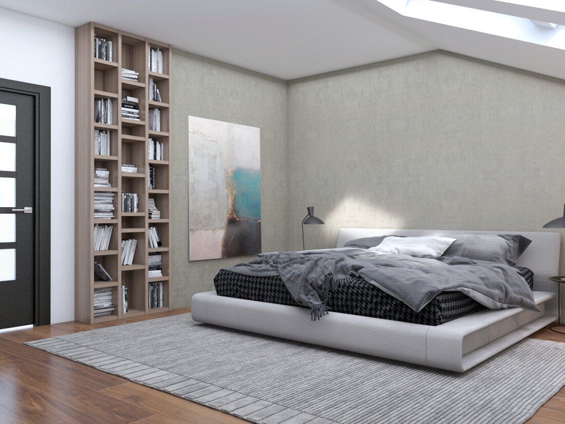 Spálňa pod strešným oknom s posteľou na koberci pri farebnej stene s abstraktným obrazom a s vysokou drevenou knižnicou