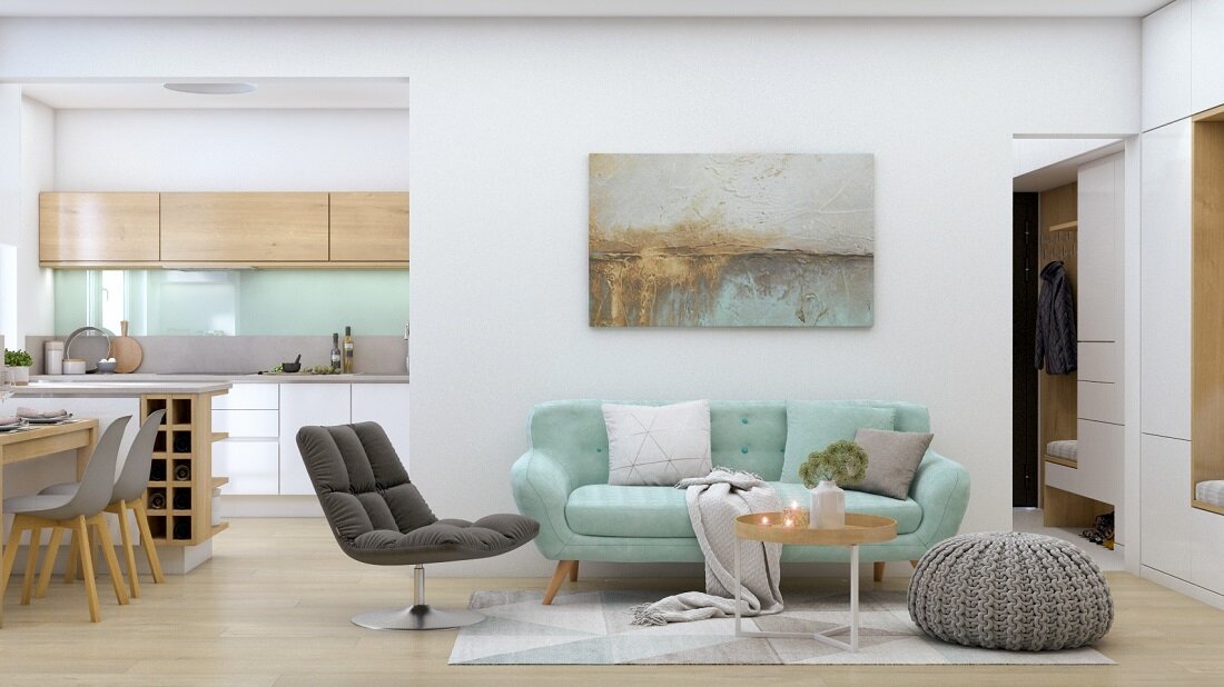 Plne dekorovaná biela obývačka s kuchyňou doplnená o mentolové a šedé farby na sedačkách, stoličkách a zástene